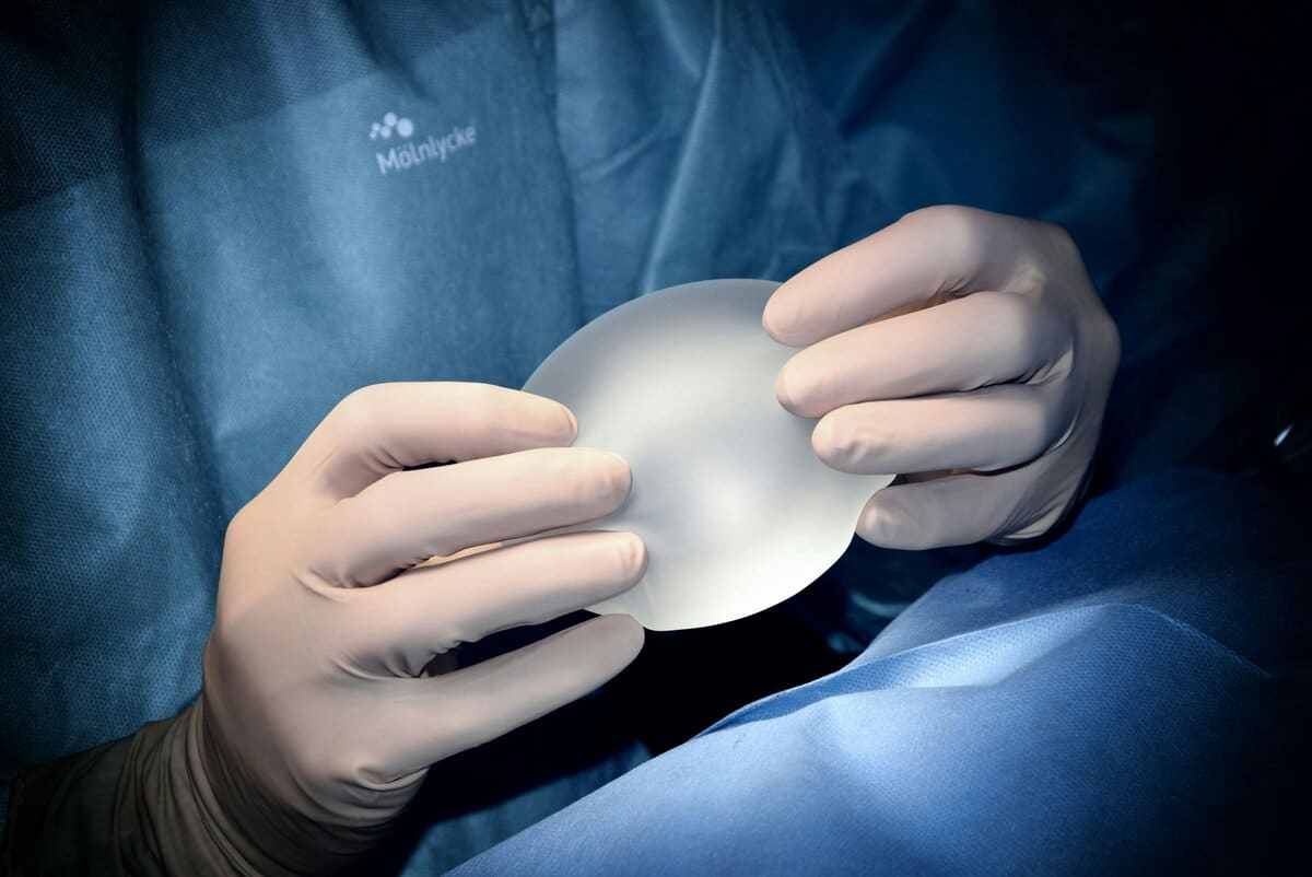doctor holds implant